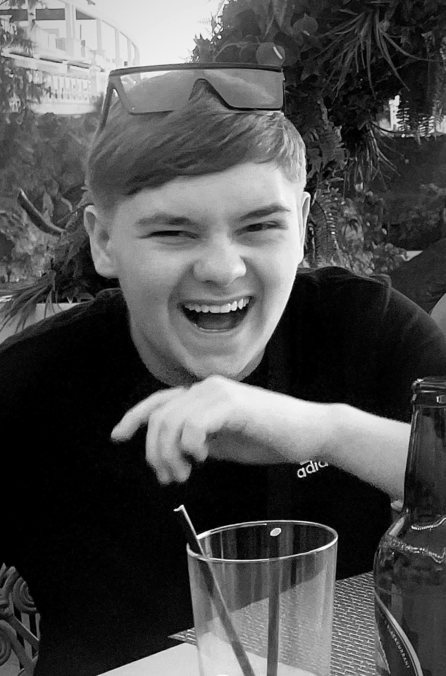 Black and white photo of a laughing young man.