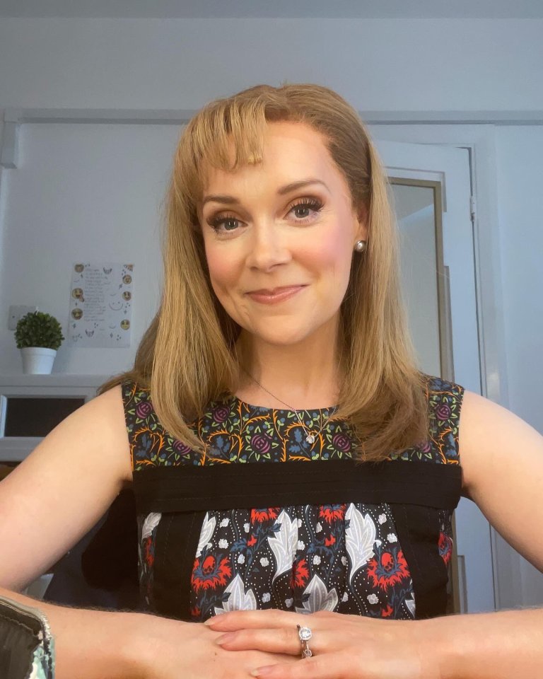 Headshot of a woman wearing a floral dress.
