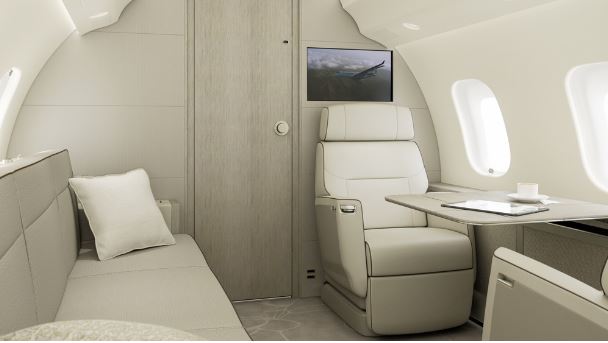 Private jet cabin interior with seating and a fold-out table.