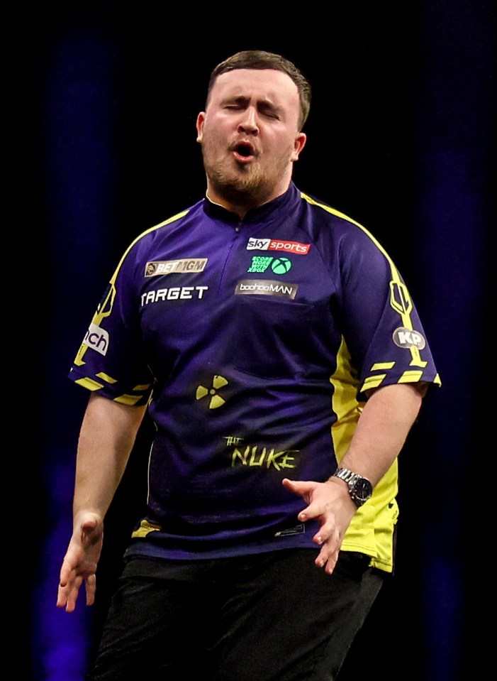 Luke Littler playing darts.