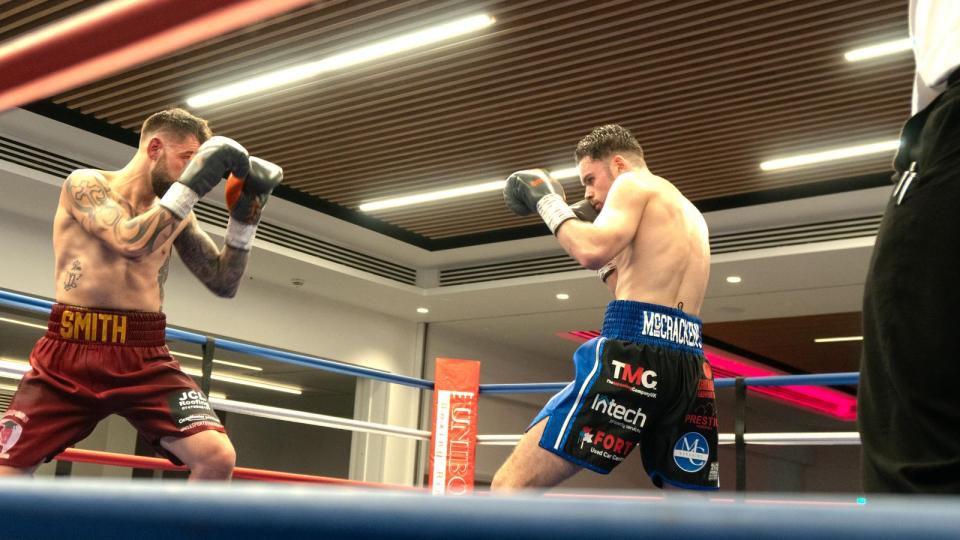 Two boxers in a boxing ring.