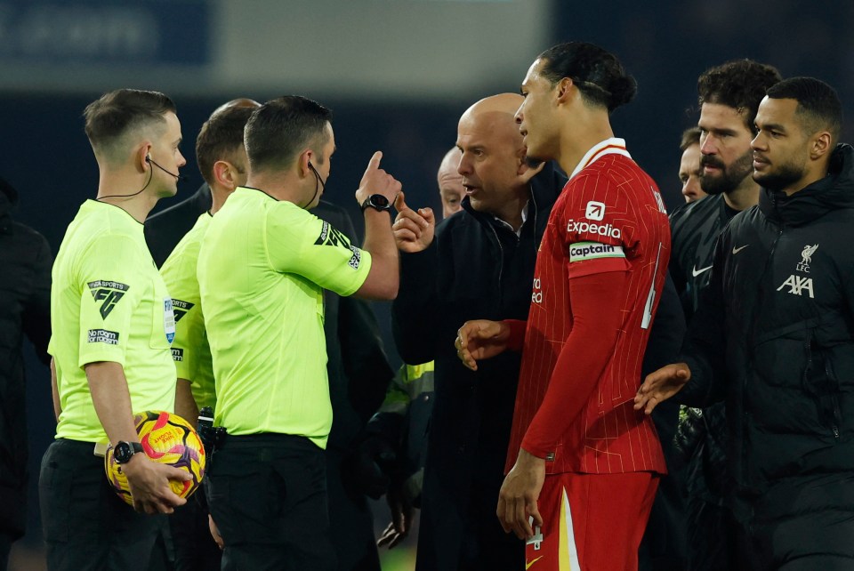 Liverpool manager arguing with a referee and player.