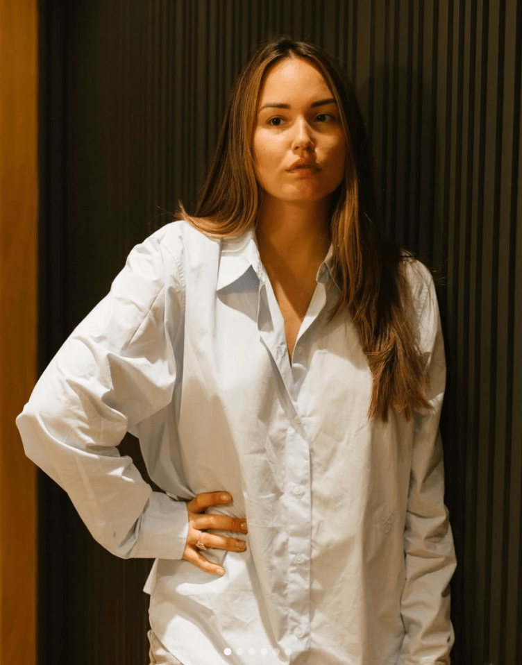 Woman in light blue oversized shirt.