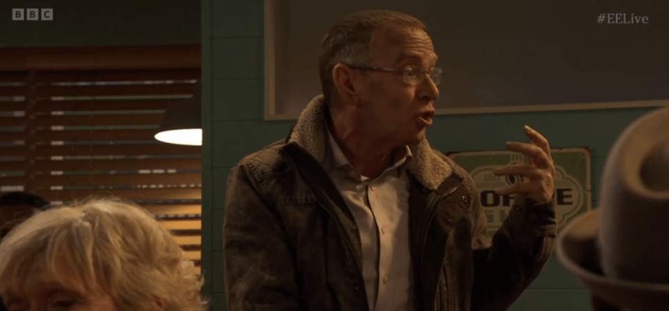 Screenshot of a man speaking animatedly.