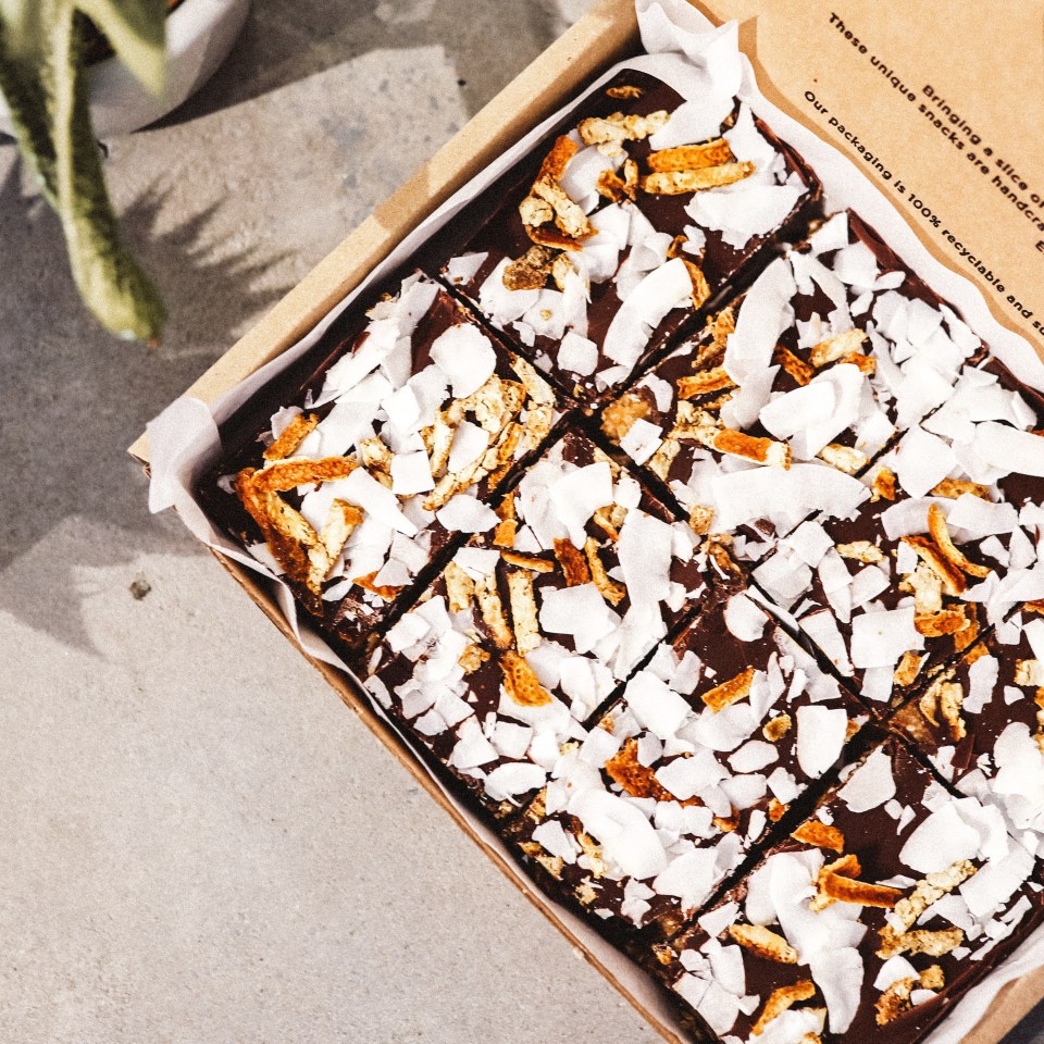 Chocolate squares topped with coconut and orange zest.