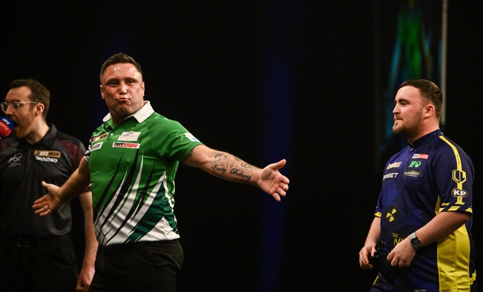 Gerwyn Price celebrates a 180 during a darts match.