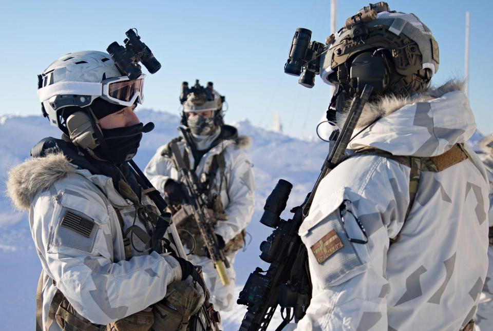 US and Danish special forces soldiers in Arctic camouflage during a military exercise.