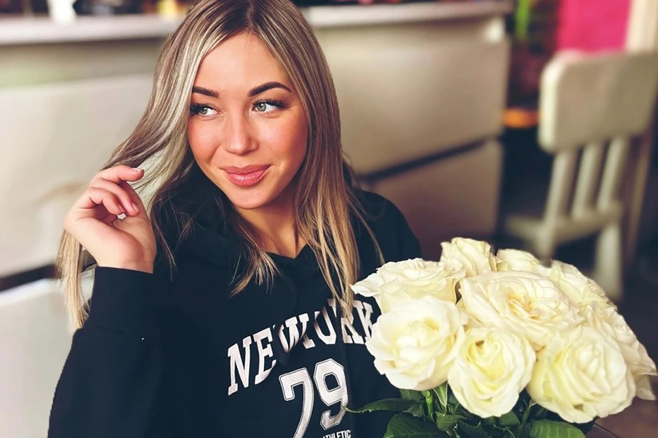 Woman holding white roses.