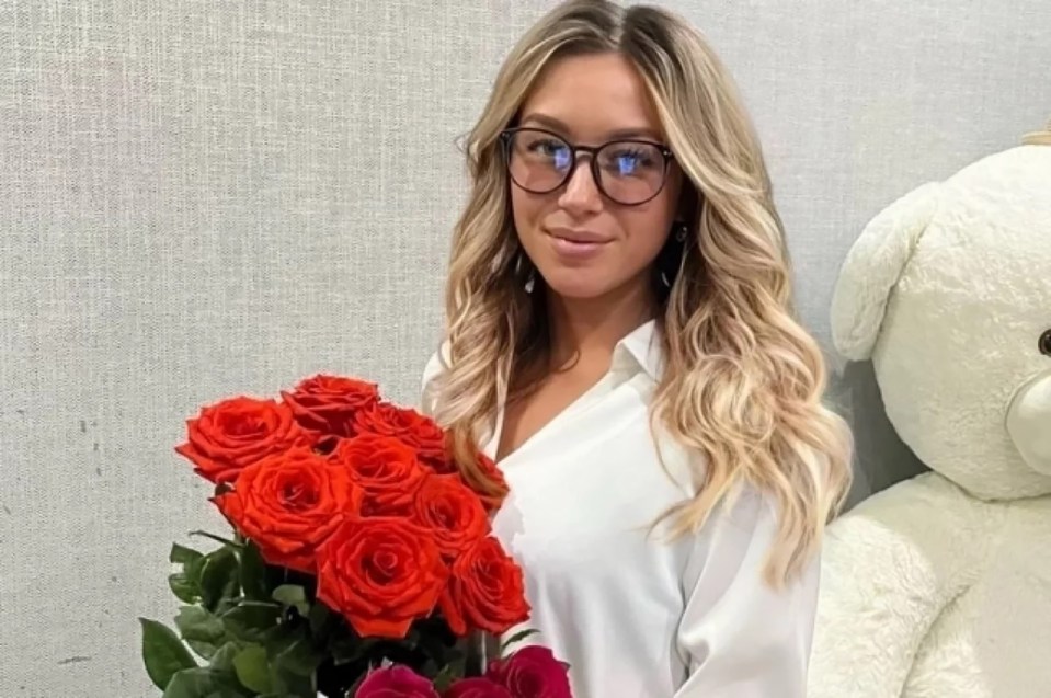 Woman holding red roses.