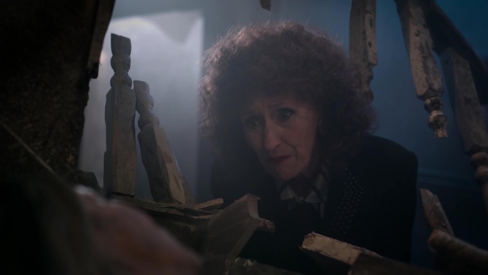 Angie Watts examining a broken chair.