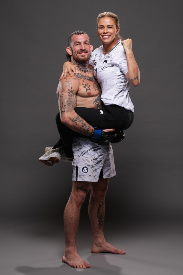 Portrait of Austin Vanderford holding his wife, Paige VanZant.