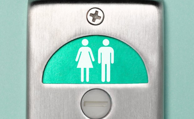 Restroom door sign indicating vacant unisex restroom.