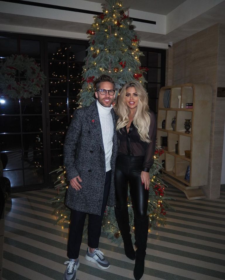 Bianca Gascoigne and Arron Wright posing together in front of a Christmas tree.