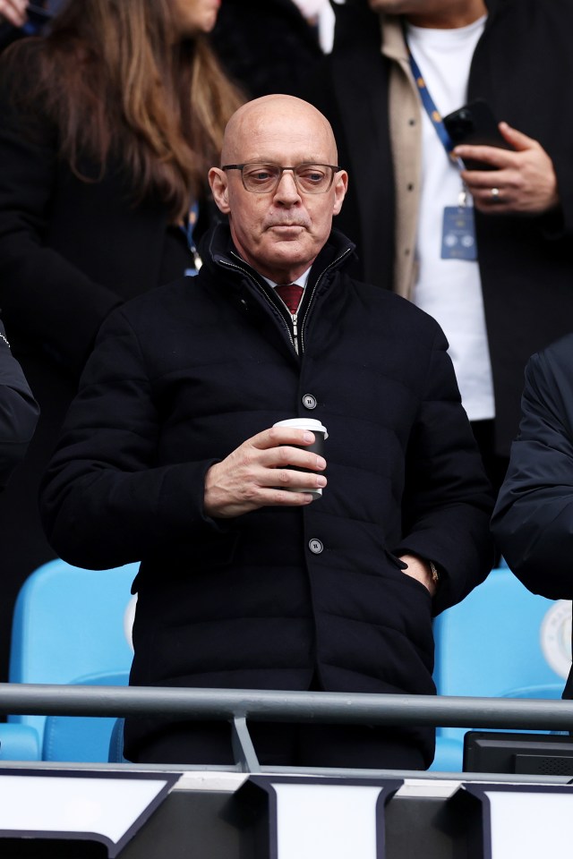 Sir David Brailsford watching a soccer match.