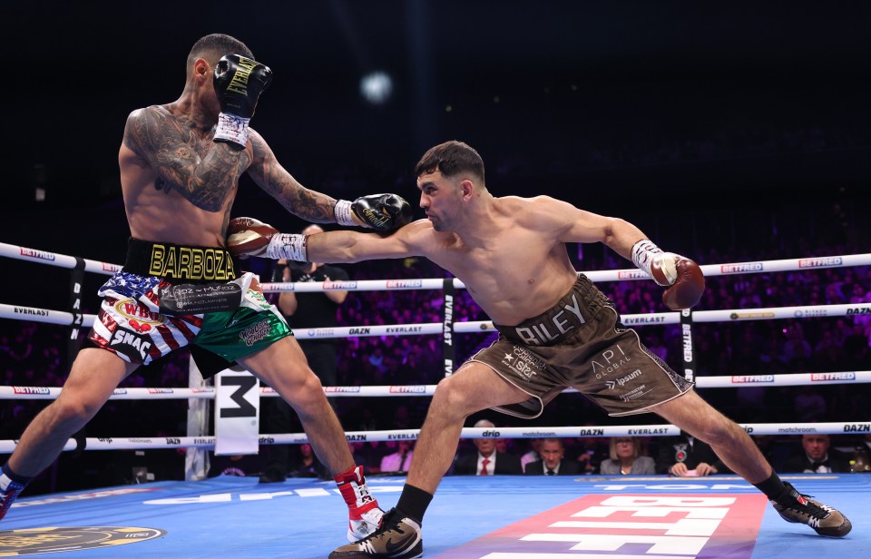 Boxers Jack Catterall and Arnold Barboza Jr. exchanging blows in a boxing match.
