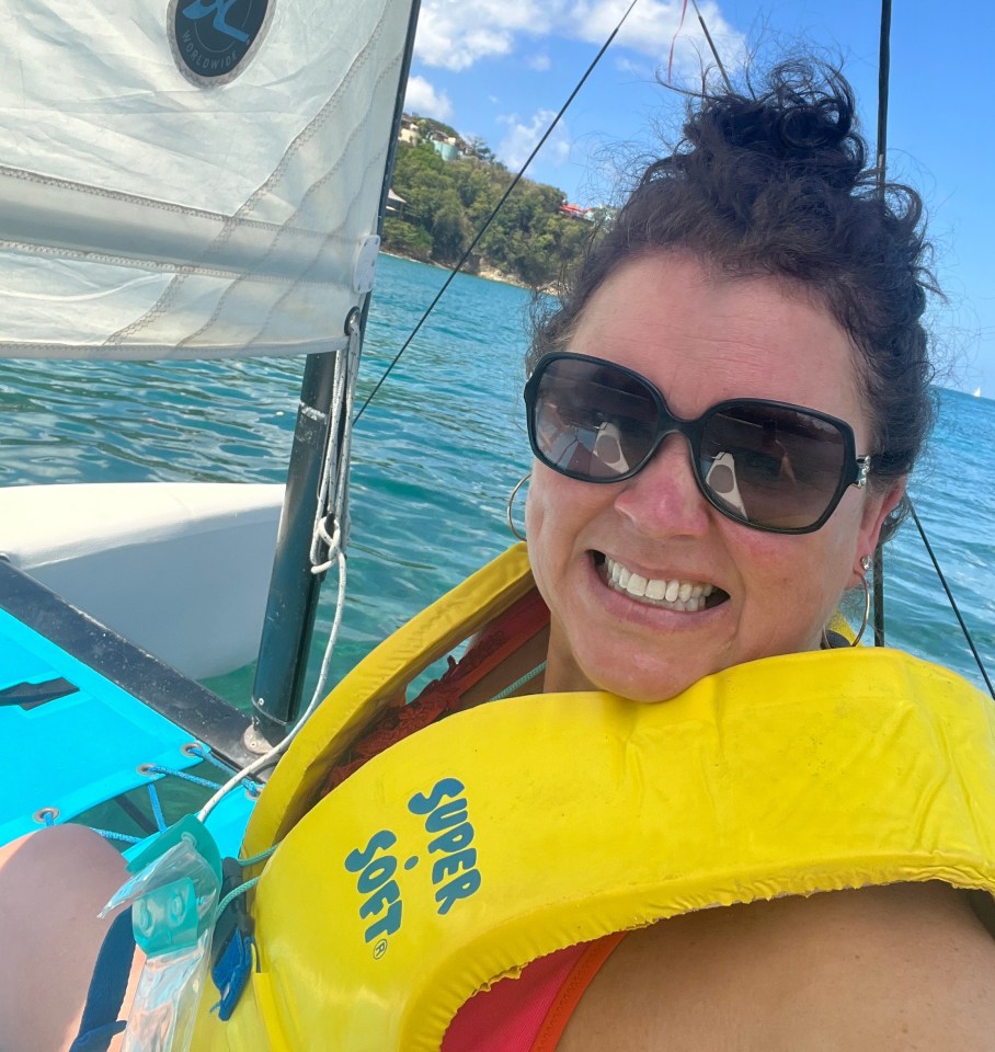 Woman smiling while sailing a Hobie Cat.