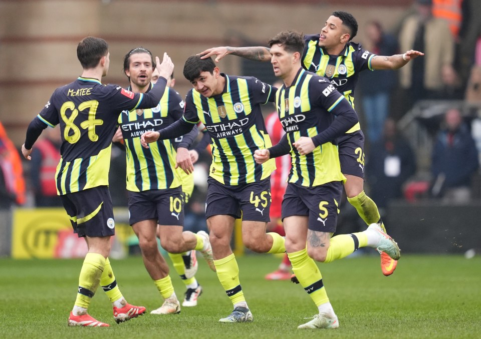 Manchester City players celebrating a goal.