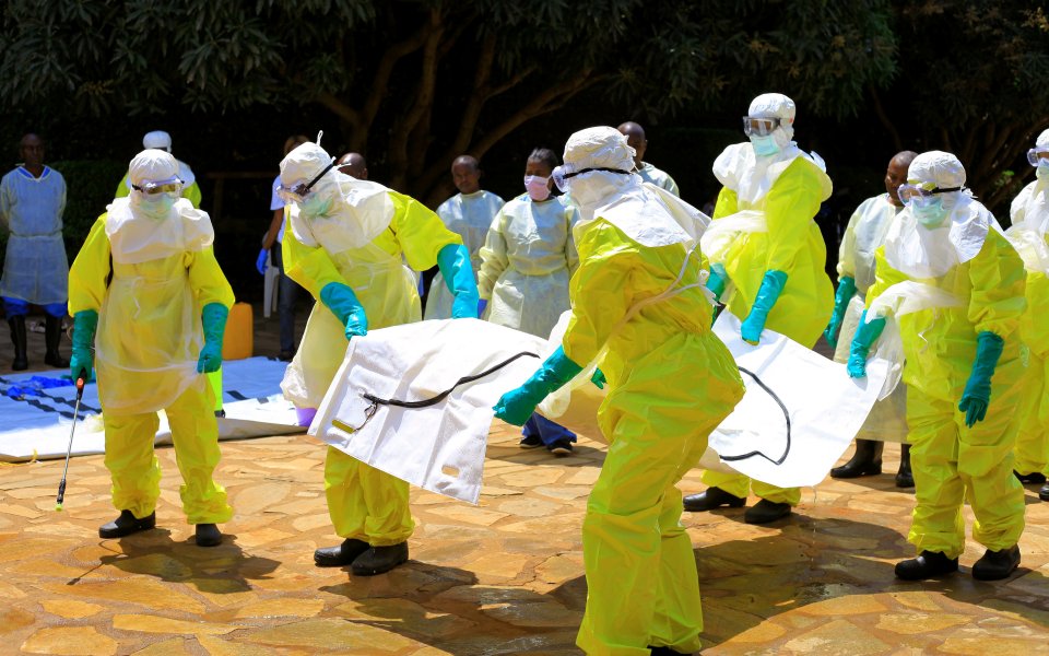 Congolese and World Health Organization officials in protective suits during Ebola virus training.
