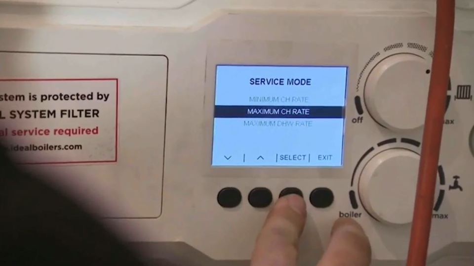 Person adjusting boiler settings.