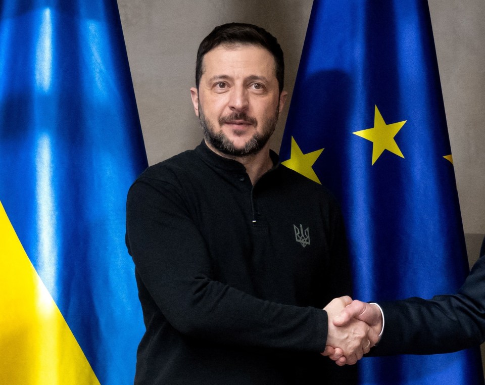 Olaf Scholz and Volodymyr Zelenskyy shaking hands.
