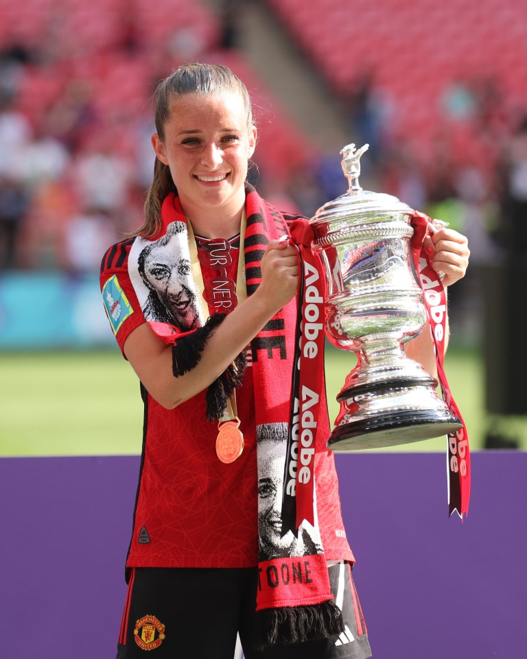 Ella Toone of Manchester United holding the Women's FA Cup trophy.