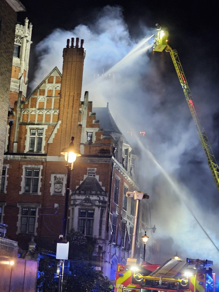 Firefighters battling a blaze at a brick building.