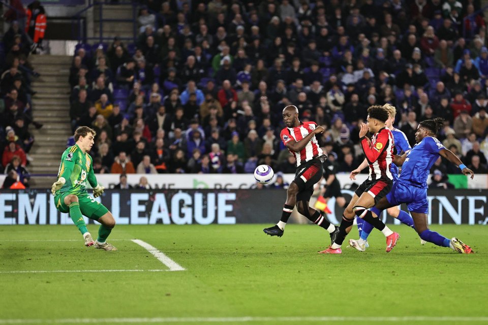 Soccer player scoring a goal.