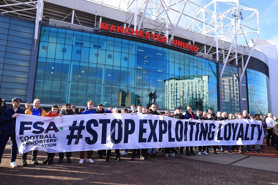 Fans at Old Trafford holding a banner that reads "#Stop Exploiting Loyalty".