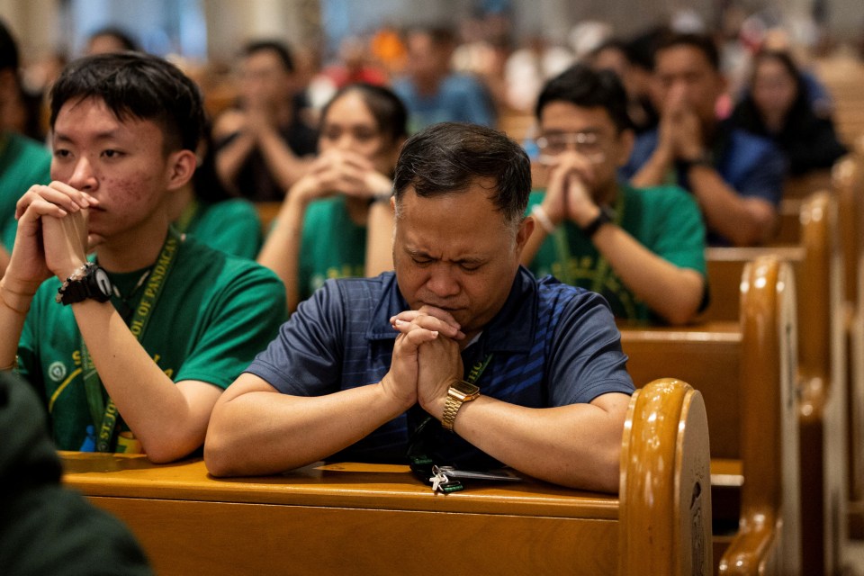 Filipino Catholics praying at Manila Cathedral.
