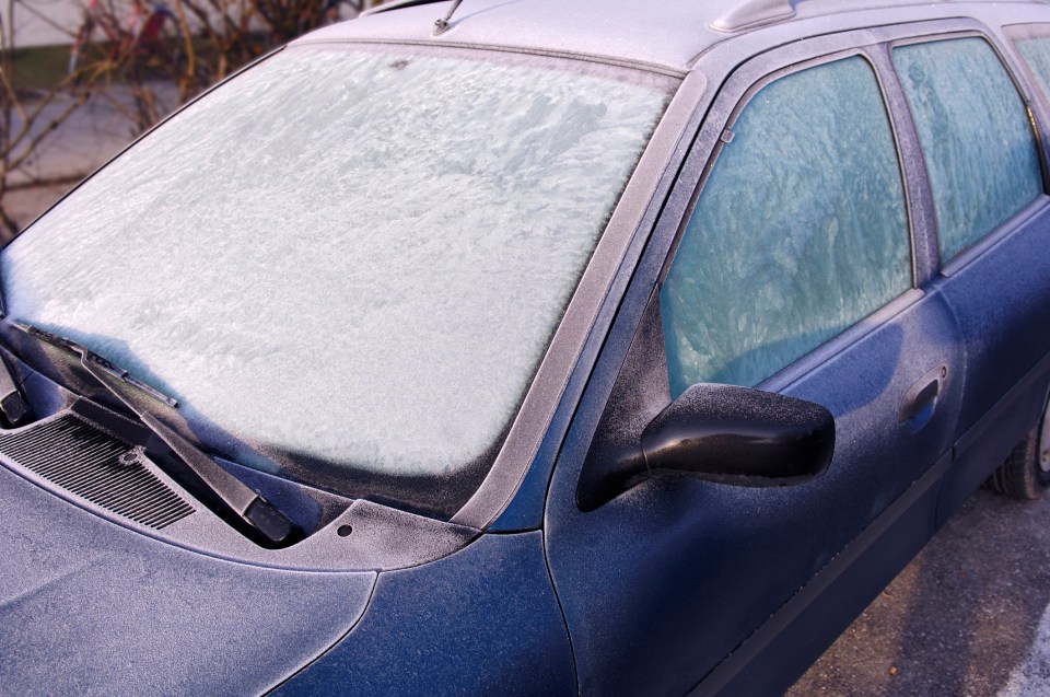 Frost covering a car's windshield and windows.
