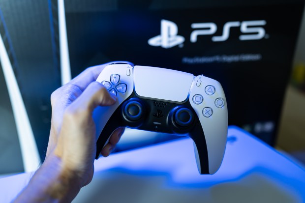 Person holding a PlayStation 5 DualSense controller.