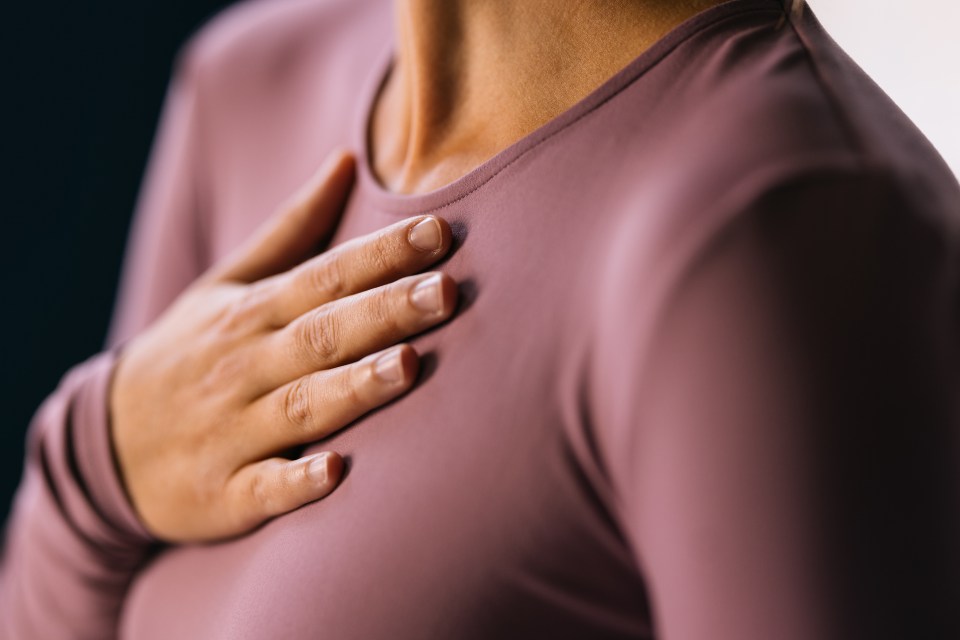 Woman's hand resting on her chest.
