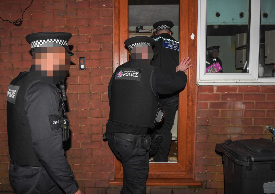 Police officers entering a house during a drug raid.