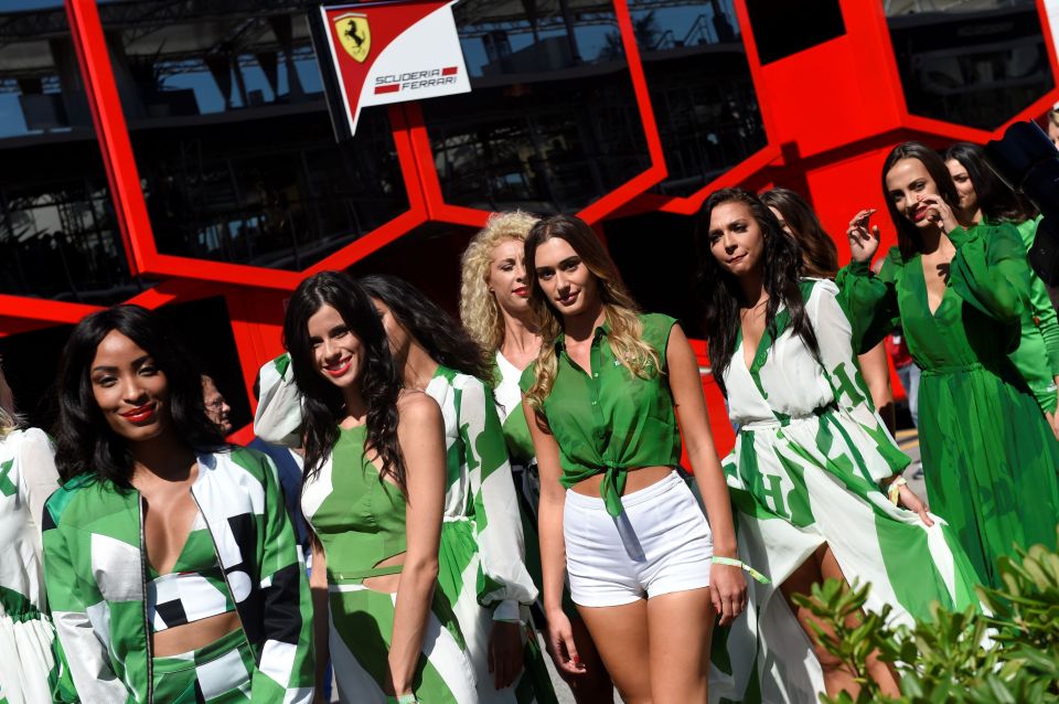 Grid girls in green and white outfits at the Italian Formula One Grand Prix.