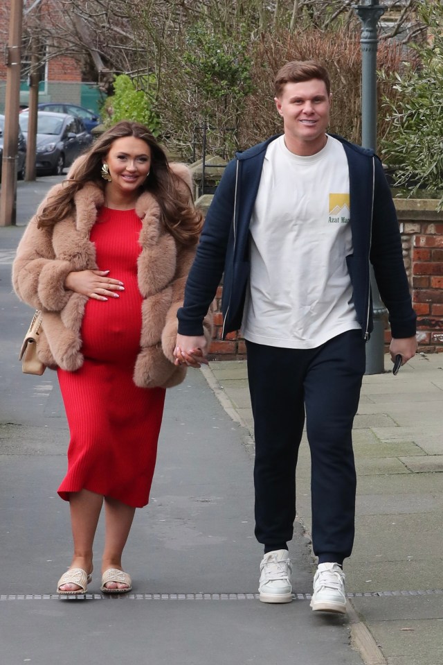 Heavily pregnant Charlotte Dawson and Matt Sarsfield holding hands.