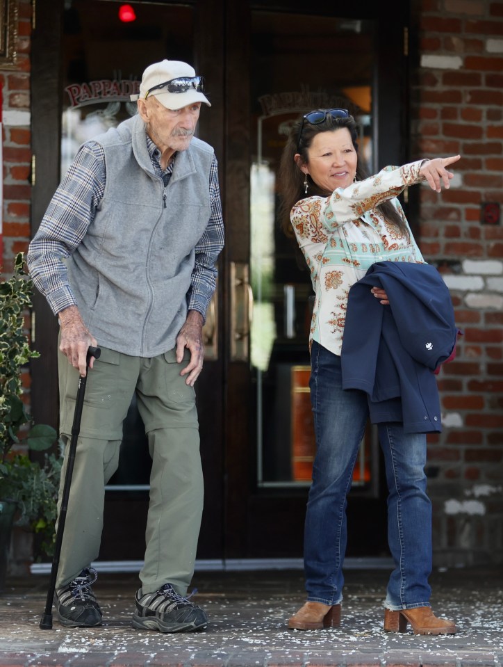 Gene Hackman and his wife leaving a restaurant.