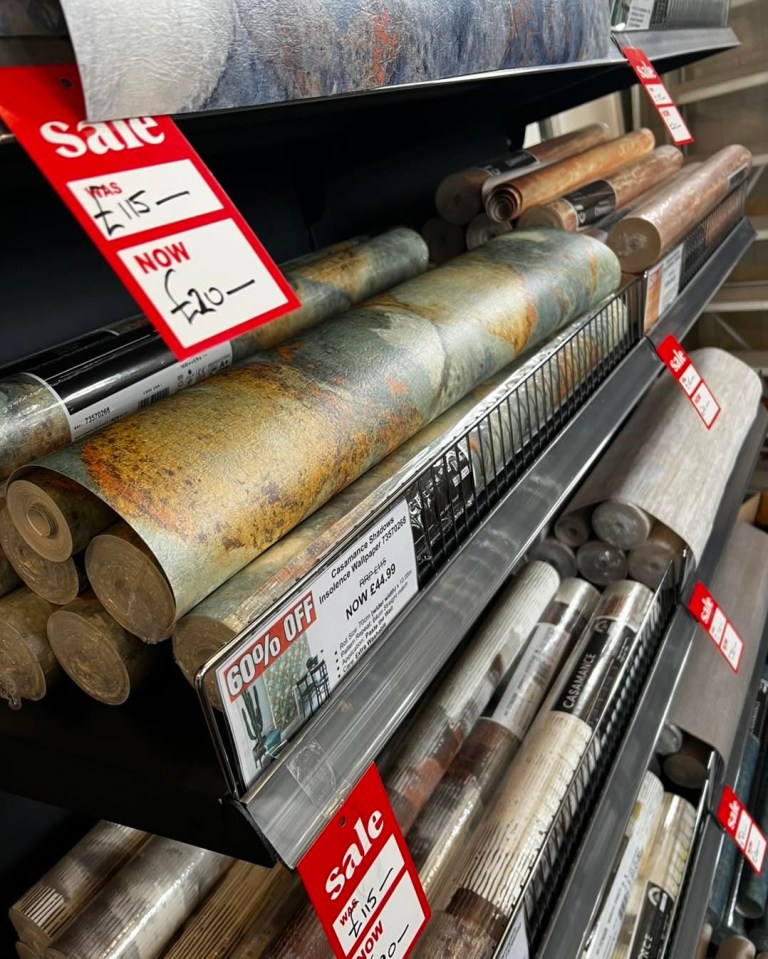 Sale of wallpaper rolls at reduced prices.