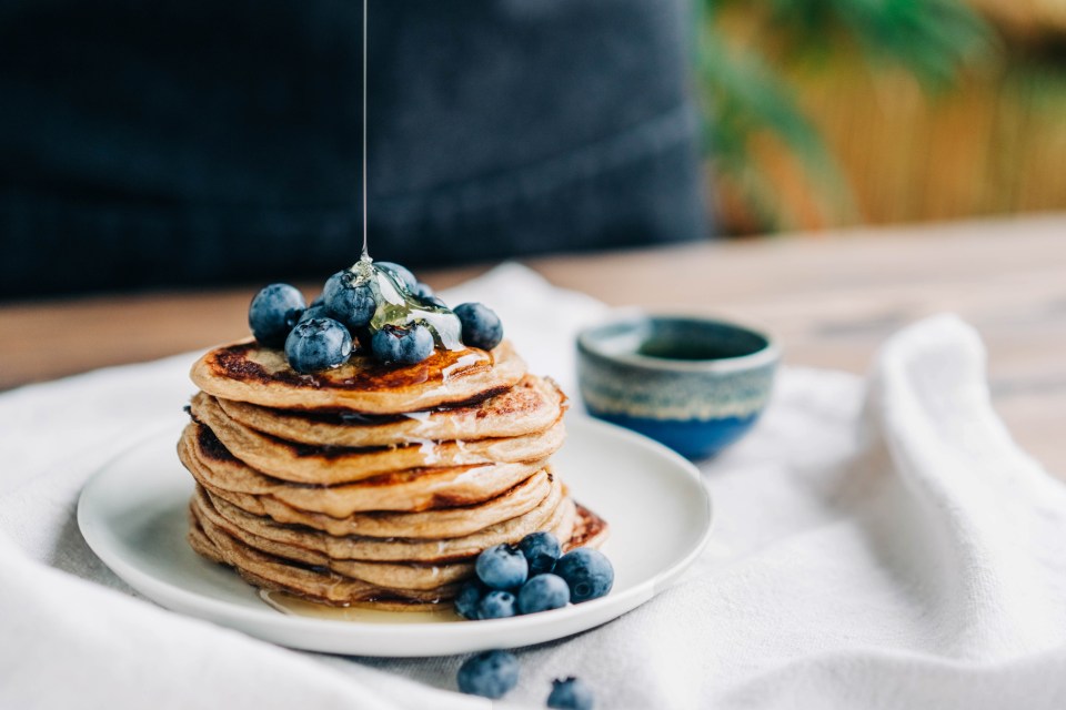 Homemade pancakes with blueberries and honey.