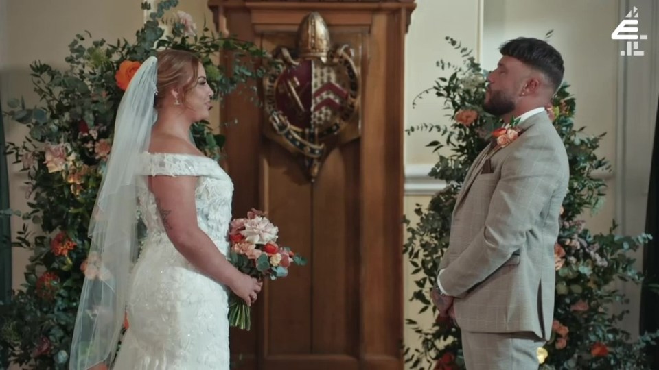 A bride and groom stand at their wedding ceremony.