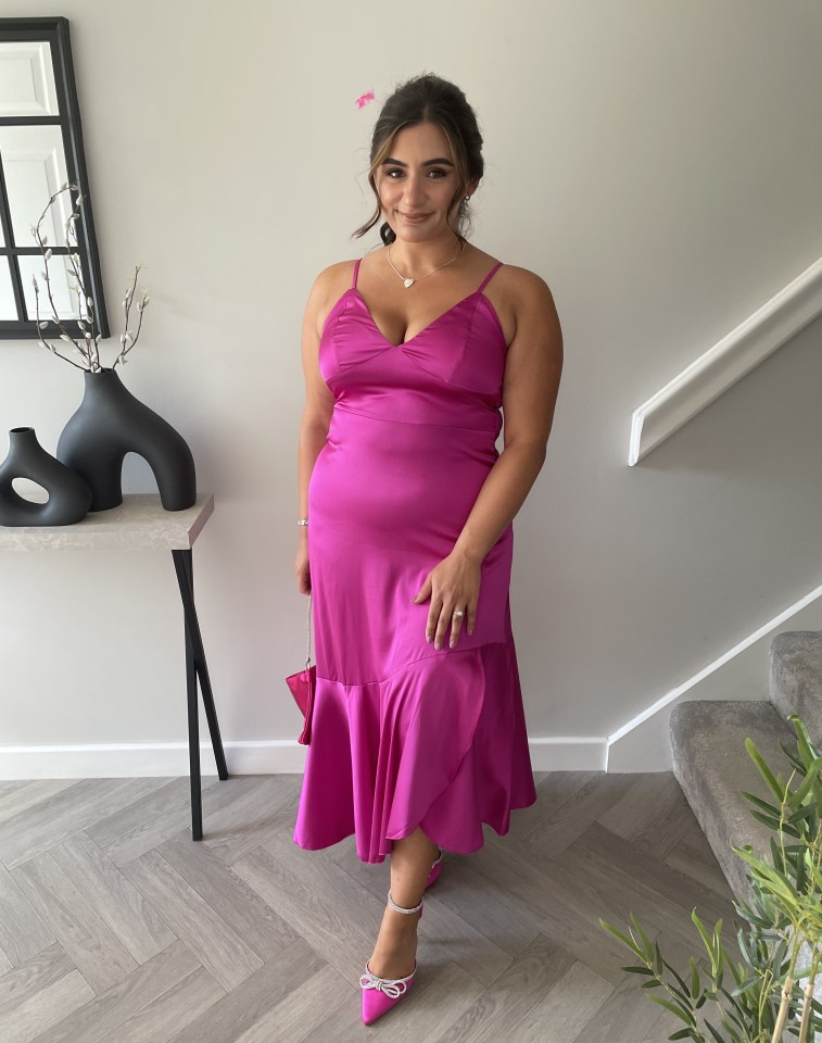 Woman in a pink dress and pink shoes.