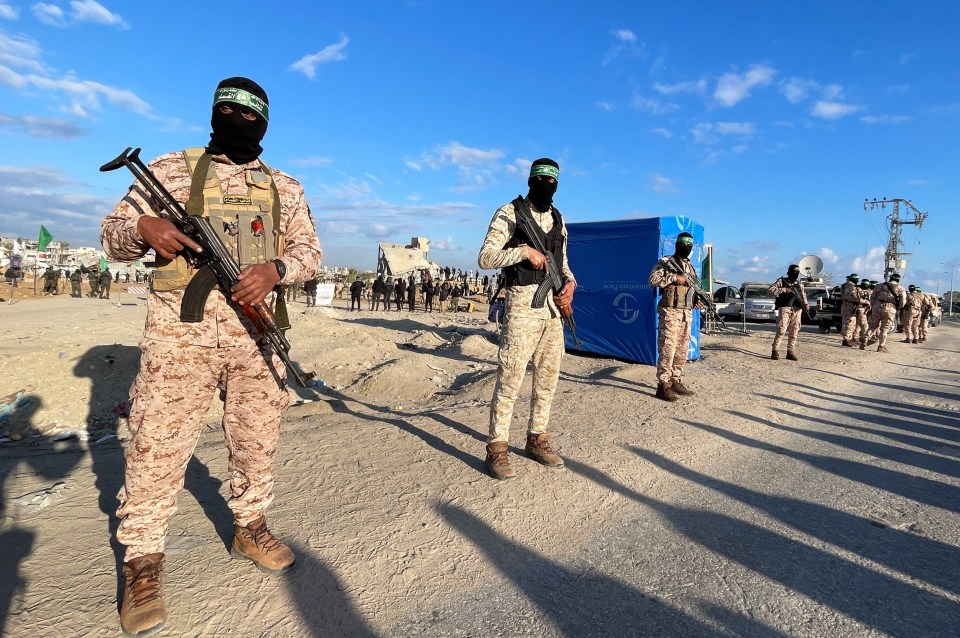 Hamas militants guarding a hostage handover in Gaza.