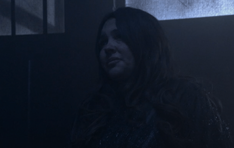 Woman with long dark hair looking off to the side.