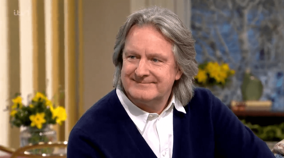 A man with graying hair smiling.