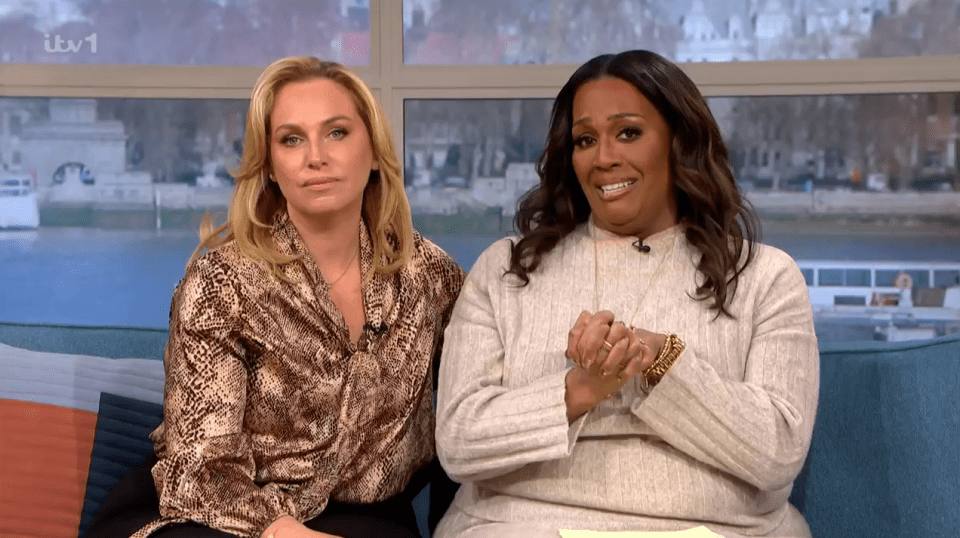 Two women sitting on a sofa.
