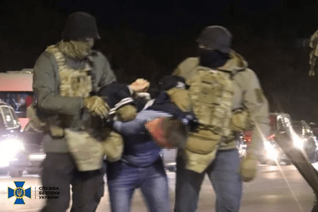 Security forces detaining a person.