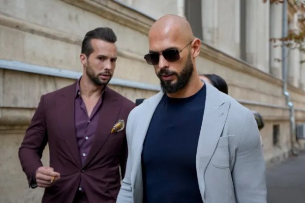 Two men in suits walking down a street.
