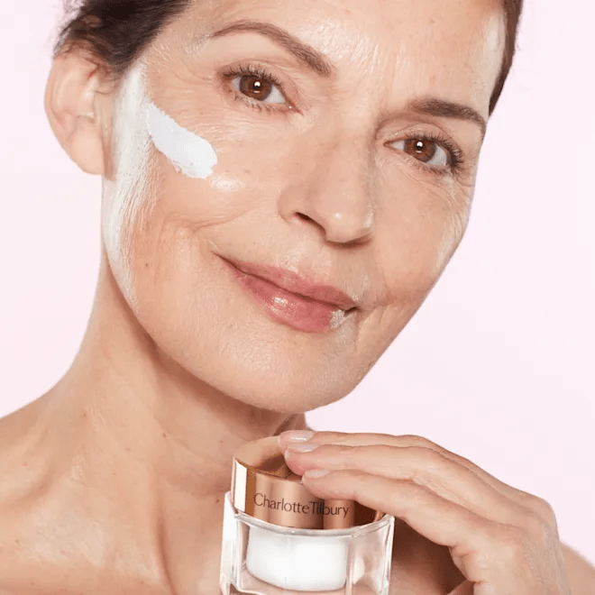 Woman applying face cream.