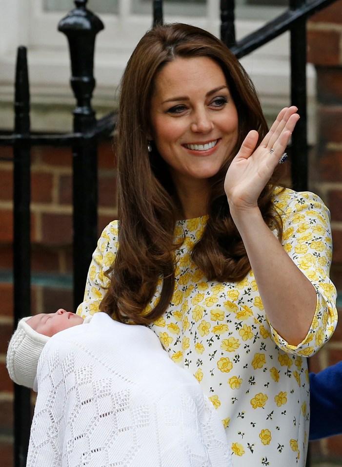 Kate Middleton holding her newborn baby daughter and waving to the media.