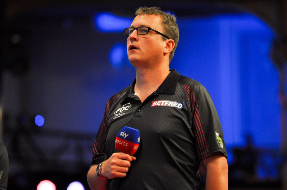 Kirk Bevins holding a Sky Sports microphone at the 2023 Betfred World Matchplay.