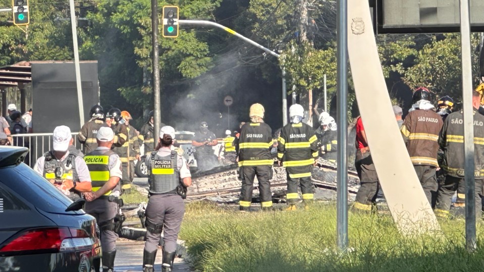 Aftermath of a small plane crash in Sao Paulo, with emergency responders at the scene.